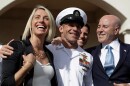 Navy Special Operations Chief Edward Gallagher, center, walks with his wife, Andrea Gallagher, left, and advisor, Bernard Kerik as they leave a military court on Naval Base San Diego, Tuesday, July 2, 2019, in San Diego. A military jury acquitted the decorated Navy SEAL Tuesday of murder in the killing of a wounded Islamic State captive under his care in Iraq in 2017.