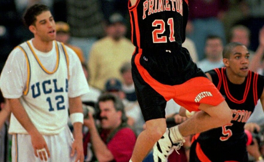 March 14, 1996: Princeton guard Mitch Henderson leaps to celebrate the Tigers' victory over UCLA as Bruins guard Toby Bailey, left, looks on in the first round of the NCAA tournament. Henderson, now a coach, has Princeton in the Sweet 16.