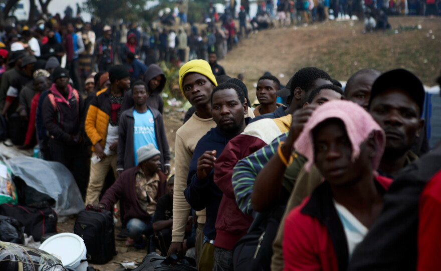 Displaced migrants queue at a deportation site in Durban, South Africa, on June 17.