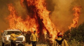 Flames from the LNU Lightning Complex fires leap above Butts Canyon Road on Sunday, Aug. 23, 2020