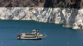 The white 'bathtub ring' on the rocks around Lake Mead is from mineral deposits left by higher levels of water. 