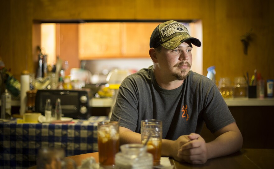 John Coffell sits at his grandmother's table in Hulen, Okla.