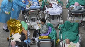 Patients are shown in hospital beds as they wait at a temporary holding area outside Caritas Medical Centre in Hong Kong on Wednesday.