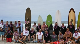 Surf invitational participants pose for a photo at Scripps Beach, Aug. 15, 2026.