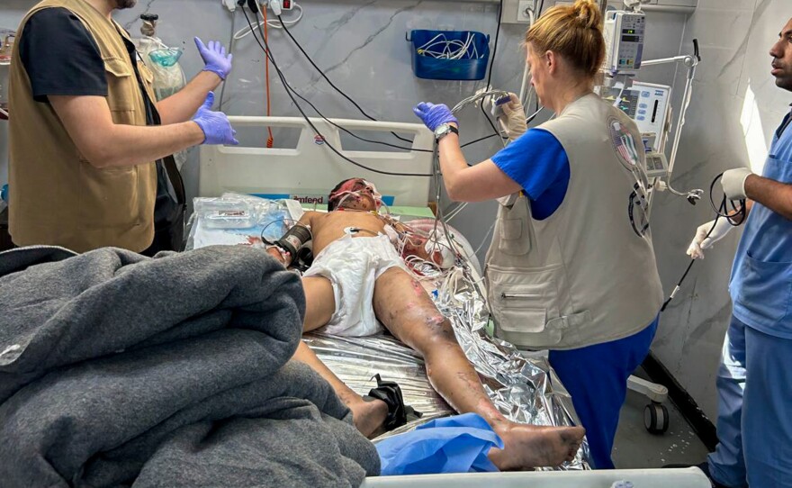 Caring for a patient at a hospital in Rafah. Needed supplies are hard to obtain due to delays caused by the Israeli military.
