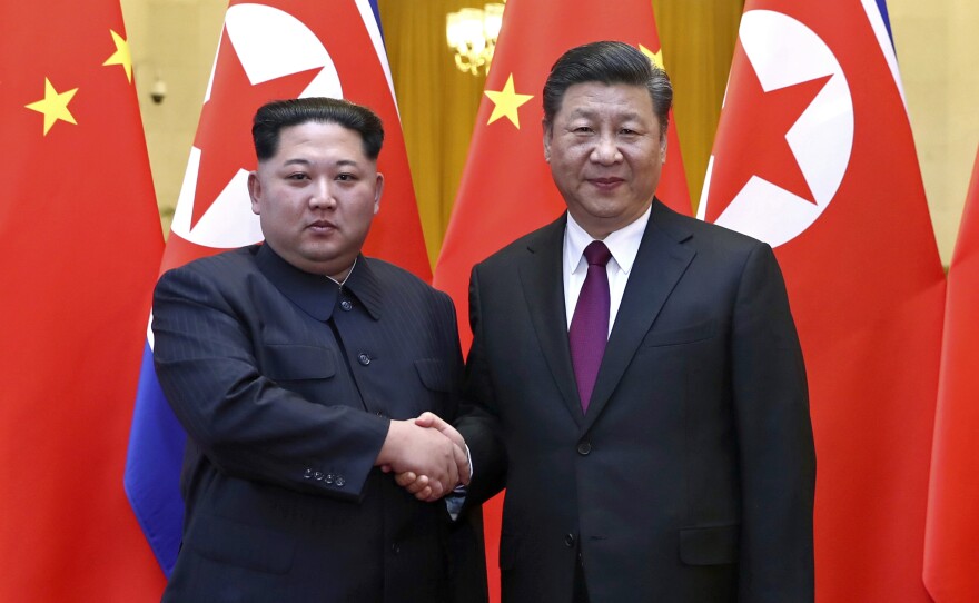 North Korean leader Kim Jong Un and Chinese President Xi Jinping shake hands in Beijing, in a this photo provided by China's Xinhua News Agency in Beijing. Kim was making his first known trip to a foreign country since he took power in 2011.