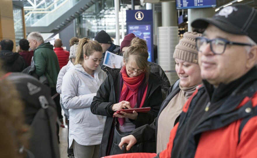 Stranded passengers who had been set to travel with Icelandic airline Wow Air are being forced to book new tickets and absorb unexpected costs after the airline shut down. Here, travelers wait in line at Iceland's international airport on Thursday.