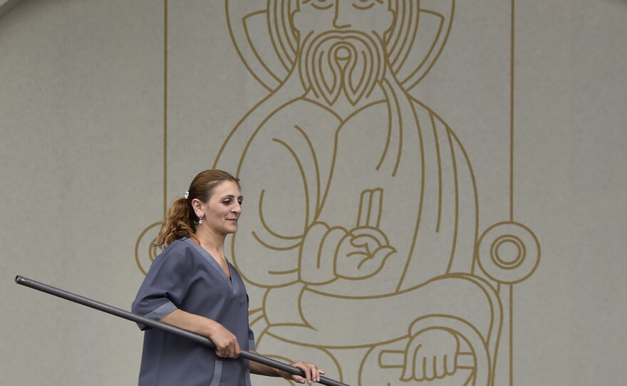 A worker puts final touches on the podium at Yerevan's Republic Square on June 23, where Pope Francis is to lead a service. The pontiff arrived in Armenia for a three-day visit on Friday.