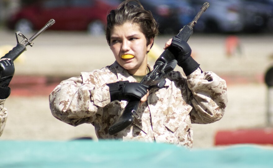 A female Marine recruit practicing close-combat fighting at Marine Corps Recruit Depot, San Diego, March 9, 2021.