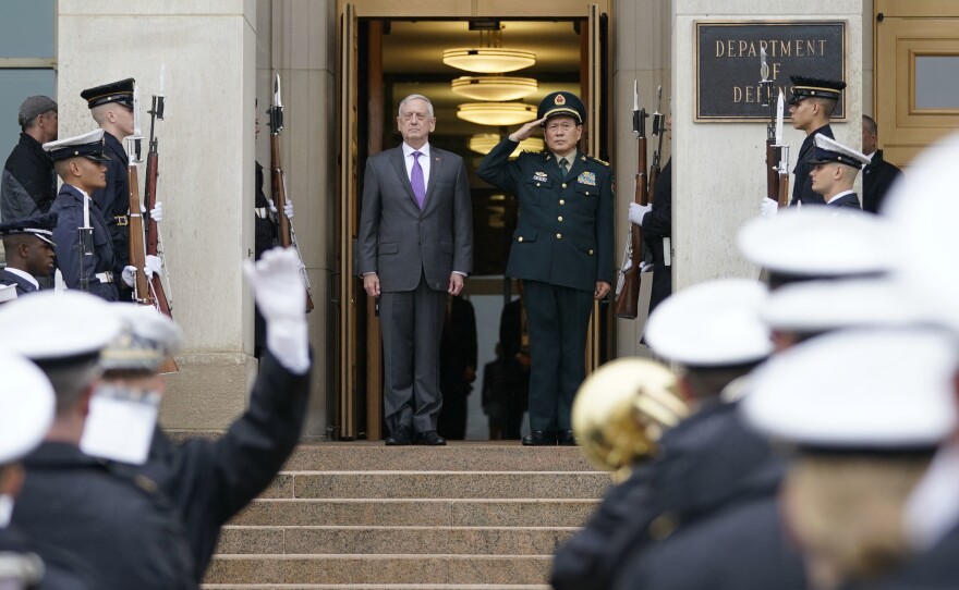 Defense Secretary Jim Mattis and China's Defense Minister Gen. Wei Fenghe stand as the national anthems are played before their meeting at the Pentagon on Friday.