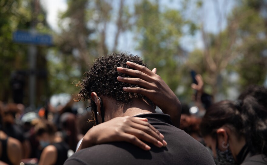 A parent and child share a tender moment during a protest against police brutality in Los Angeles on June 6.