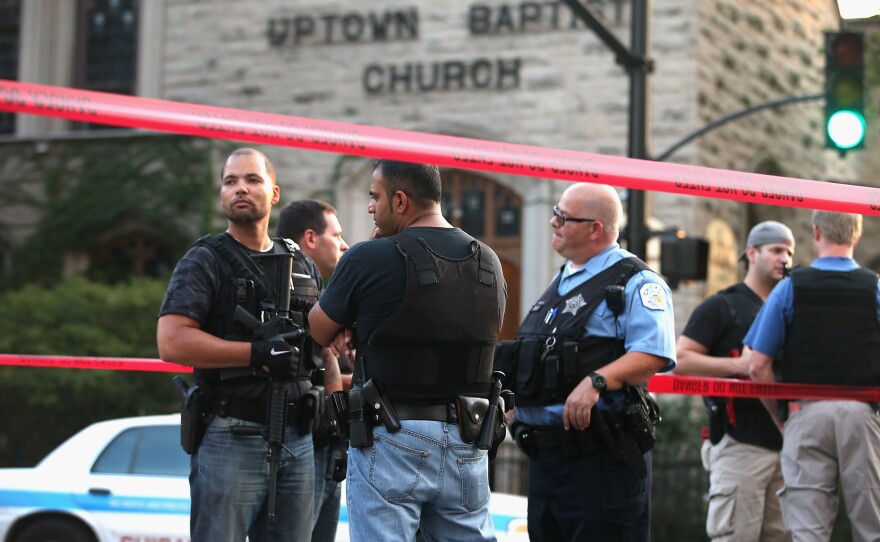 Chicago police investigate a shooting in front of the Uptown Baptist Church in August. Five people were shot, one fatally, during the drive-by, in which gunmen fired more than 20 rounds.