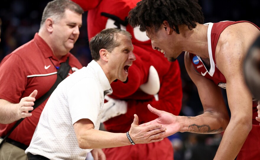 Jaylin Williams of the Arkansas Razorbacks celebrates with head coach Eric Musselman after defeating the Gonzaga Bulldogs 74-68 in the Sweet Sixteen round game of the 2022 NCAA Men's Basketball Tournament.