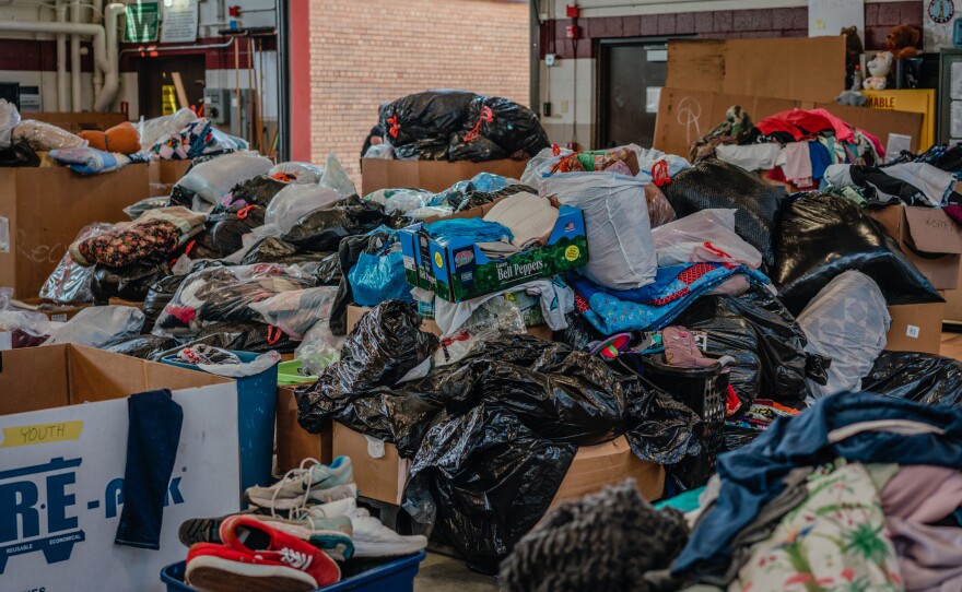 Volunteers have sorted the bags of clothing for the refugees so they can find what they need. Many arrived with only the clothes on their back.