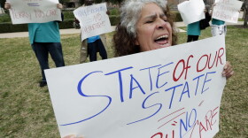 Maria Webster joins others protesting Texas Gov. Rick Perry's stance against the Affordable Care Act in early 2013.
