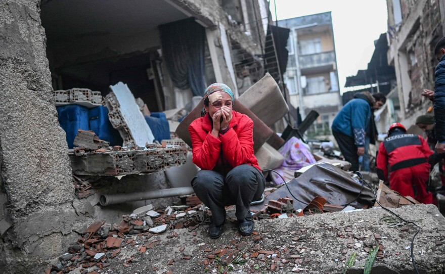 An earthquake survivor reacts as rescuers look for victims and other survivors in Hatay, Turkey, on Tuesday. A 7.8 magnitude earthquake struck Turkey and Syria in February.