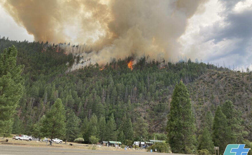 In this photo provided by Caltrans, smoke rises from the Head Fire in Klamath National Forest, Calif., on Tuesday Aug. 15, 2023.