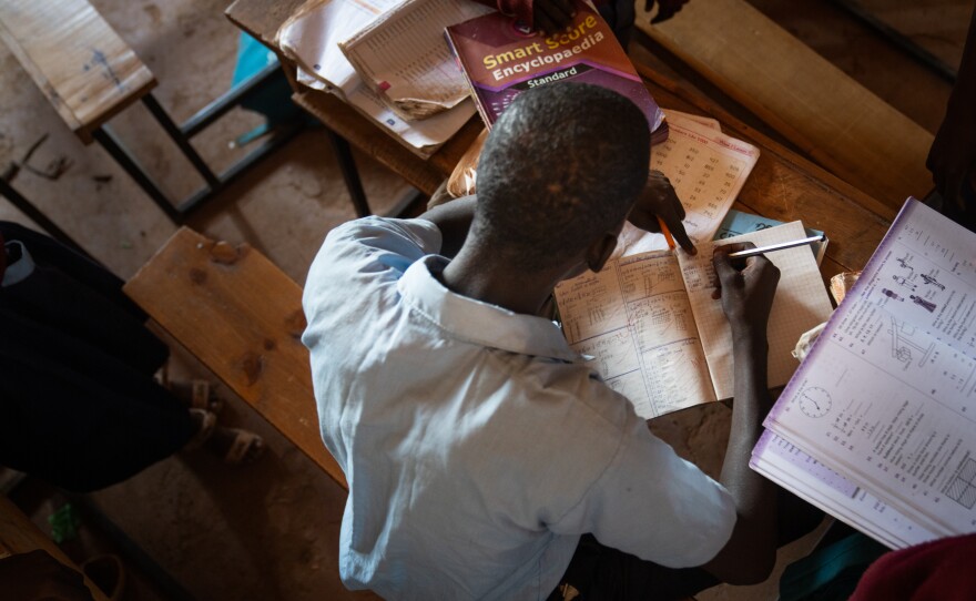 Paris works on his math homework. He says within days of starting school he had a realization: "I want my moran brothers here with me."