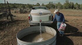 Mark Ragsdale refills a stock tank, July 17, 2026 in Redvale, Colo.