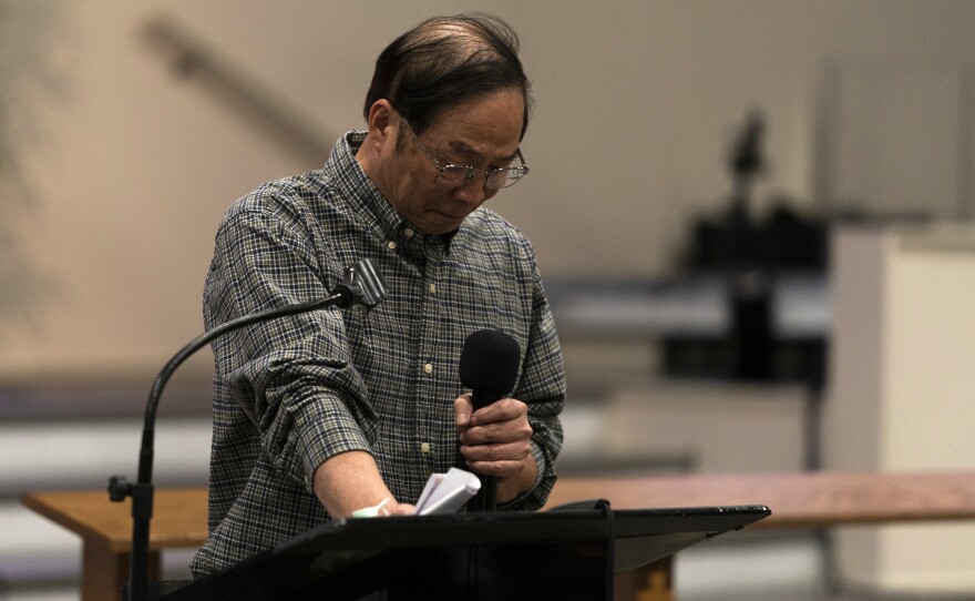 Billy Chang, a Taiwanese pastor who survived Sunday's shooting at Geneva Presbyterian Church, gets emotional while speaking at a prayer vigil in Irvine, Calif., on Monday.