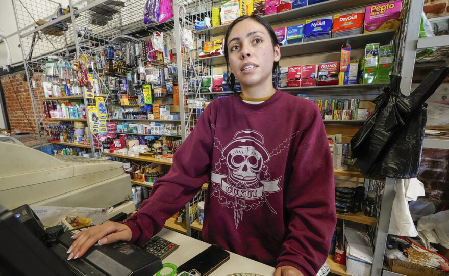 College student Jimena Sanchez, right, who studies children's development works as a part-time cashier earning minimum wage at a family store, in Los Angeles on Oct. 11, 2024.