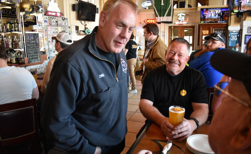 Former Interior Secretary Ryan Zinke, left, speaks with patrons at Metals Sports Bar and Grill on May 13 in Butte, Mont. Zinke is seeking election to a newly created U.S. House district.