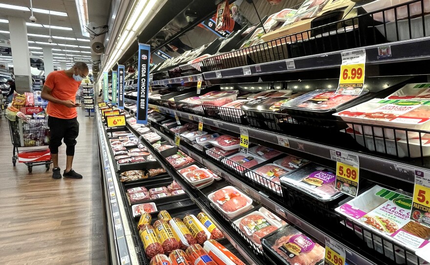 A person shops in the meat section of a grocery store in Los Angeles on Nov. 11. Surging inflation poses a special burden on lower income households as well as vulnerable populations such as the elderly who tend to live on fixed incomes.