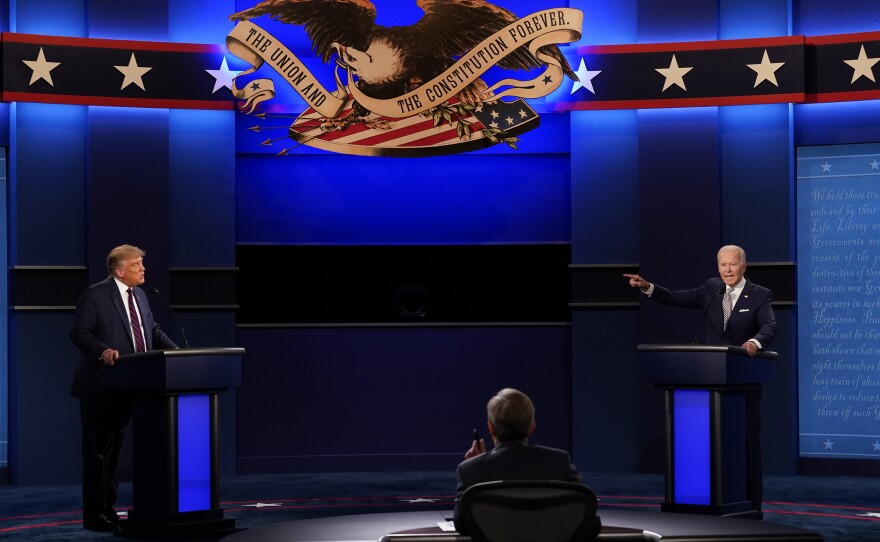 President Donald Trump, left, Democratic presidential candidate former Vice President Joe Biden, right, speaking during the first presidential debate with moderator Chris Wallace of Fox News, center, at Case Western University and Cleveland Clinic, in Cleveland, Ohio.