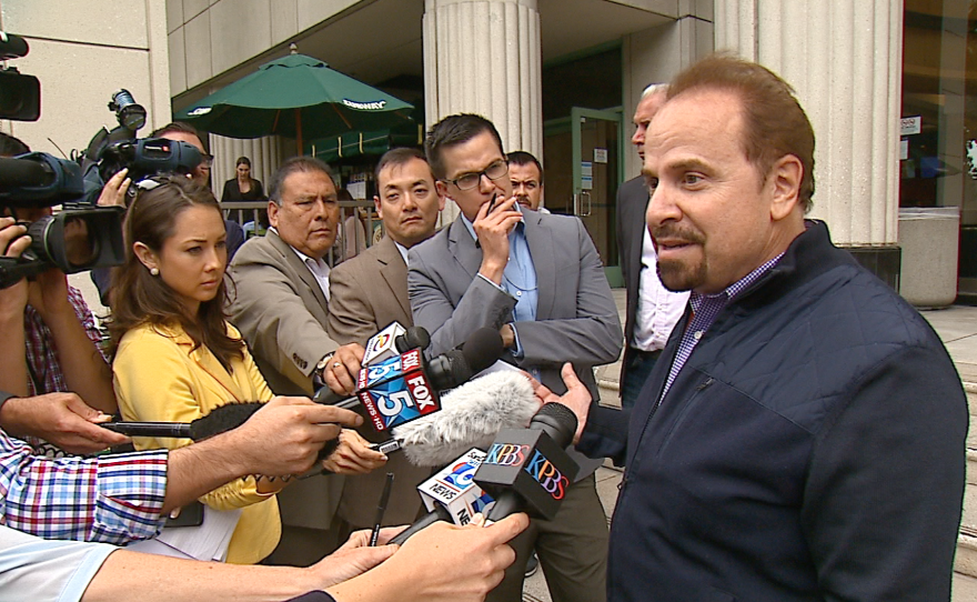 Gary Gartner, spokesman for San Diego County Supervisor Dave Roberts, addresses reporters in front of the Hall of Justice in downtown San Diego, June 11, 2015.