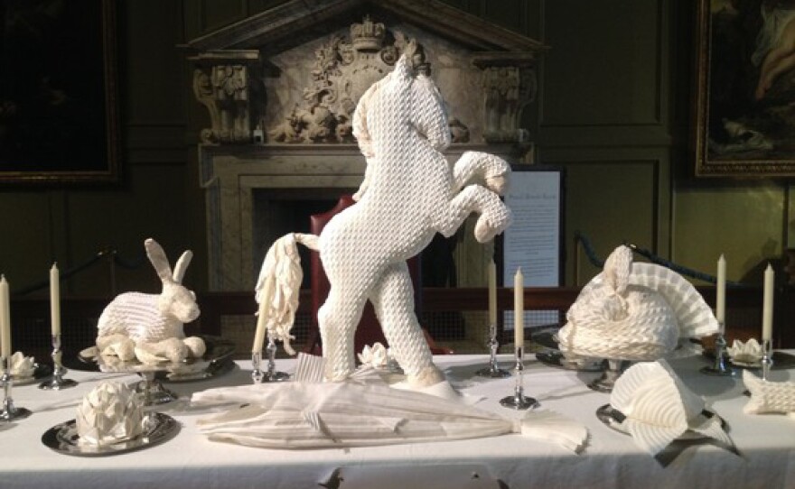 Though today we see these folded sculptures as simple decoration, 16th century guests would have been well aware of the symbolism behind each choice. These examples of napkin art were on display at Hampton Court Palace outside London in 2014.