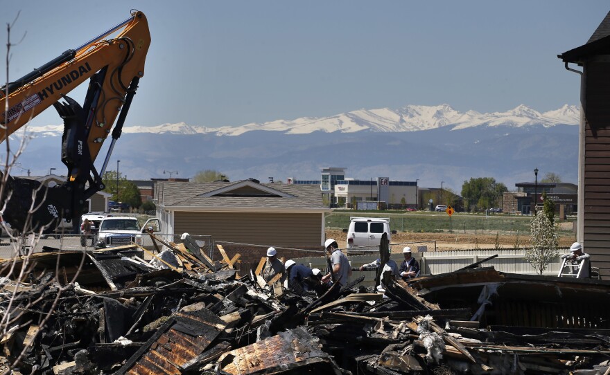 On May 4, workers dismantle the charred remains of a house in Firestone, Colo., where an unrefined gas line leak explosion killed two people in April.