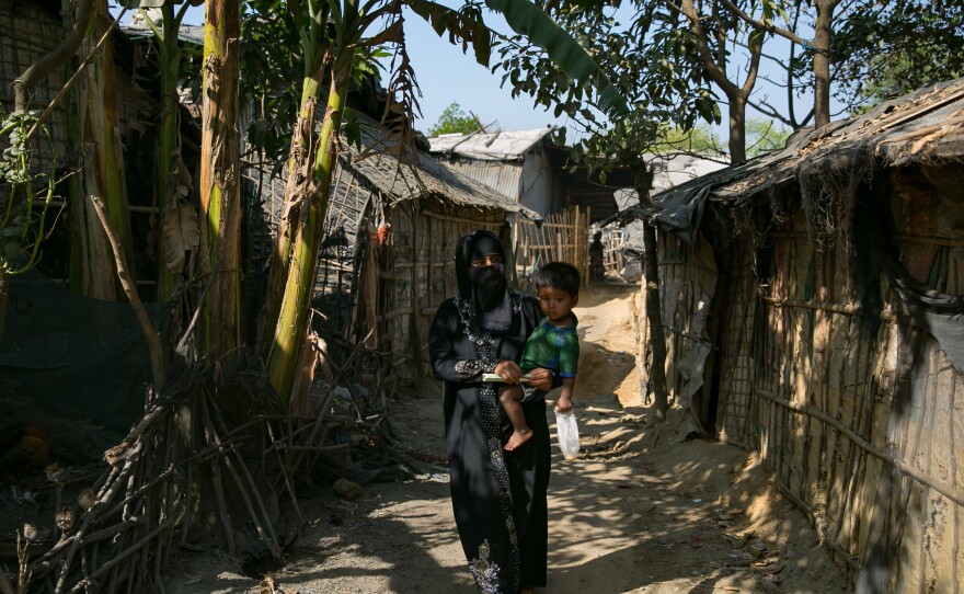Sanura Begum walks with her son, Abdur Sobor, through the Kutupalong camp in Bangladesh. This refugee camp is now the largest in the world, with 547,000 Rohingya living there.