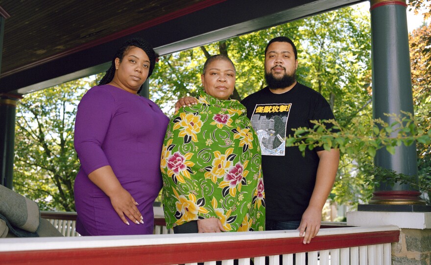 Bruner stands with her children Portia and Kevin Hurtt on the front porch of their home in Washington, D.C. The family has been together during the pandemic and has used this time to consider the legacy of Tulsa and the family's heritage.