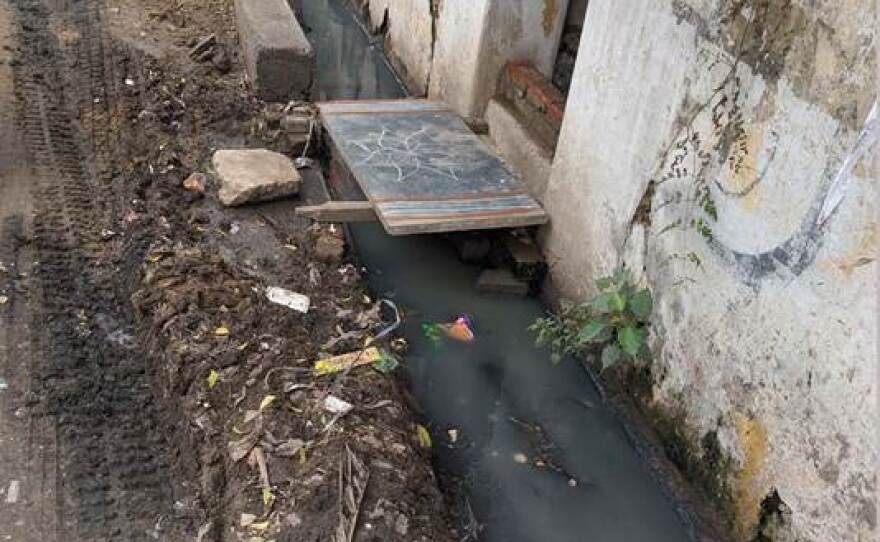 Open sewage running alongside households in Vellore, India. Poor sanitation practices can lead to rapid spread of typhoid, which can be contracted by contact with infected feces.