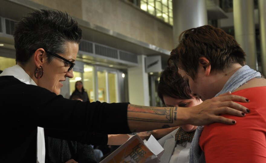 Pastor Nadia Bolz-Weber, shown here officiating civil union ceremonies in Denver in May, wrote a book on faith that recently landed on