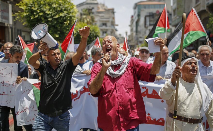 Palestinians in the occupied West Bank town of Ramallah protest the Trump administration's new peace plan on June 15.