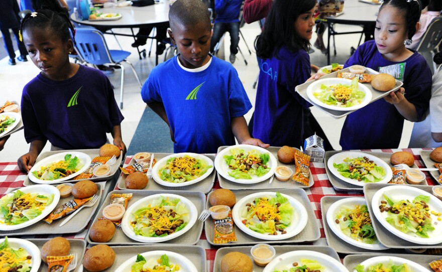 SOAR Charter school in Denver, Colo., is one of many schools that's serving more vegetarian meals. Keshan Pride, 6, in blue, looks over his choices for lunch during lunchtime at school in 2011.