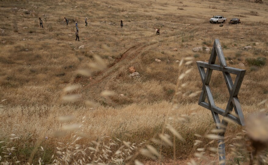 Members of the Evangelical group Hayovel take care of trees they planted earlier in the year outside if the Israeli settlement of Gitit on April 18, 2024.