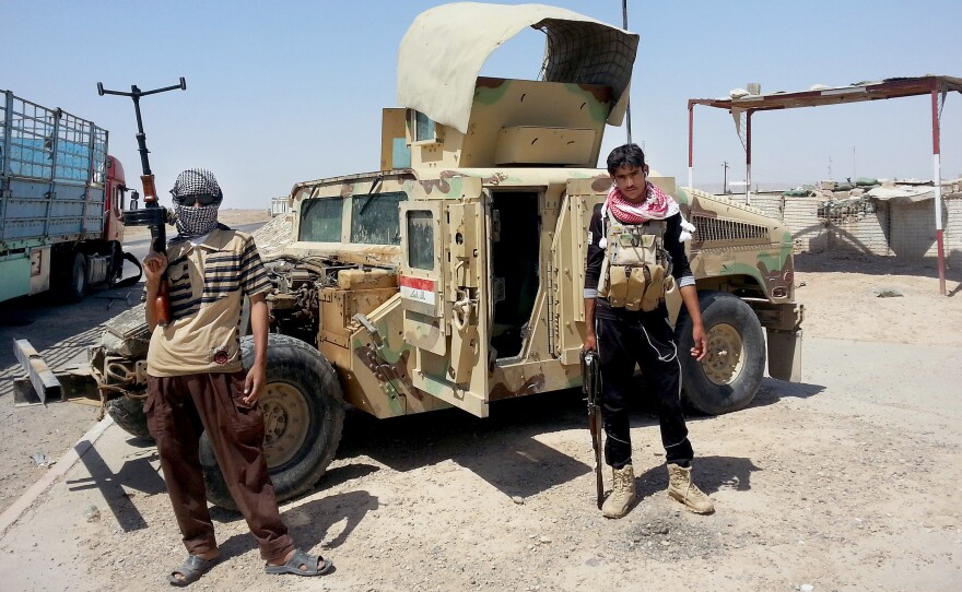 Militants of the Islamic State stand with a captured Iraqi army Humvee outside Beiji oil refinery, about 150 north of Baghdad, Iraq, in June 2014. While there is increased radicalization in many parts of the Arab world, there are also groups and individuals working to deradicalize young Muslim men.