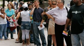 <strong>We Could Be Somewhere Else Now:</strong> People wait in line outside the U.S. passport office in downtown Washington.