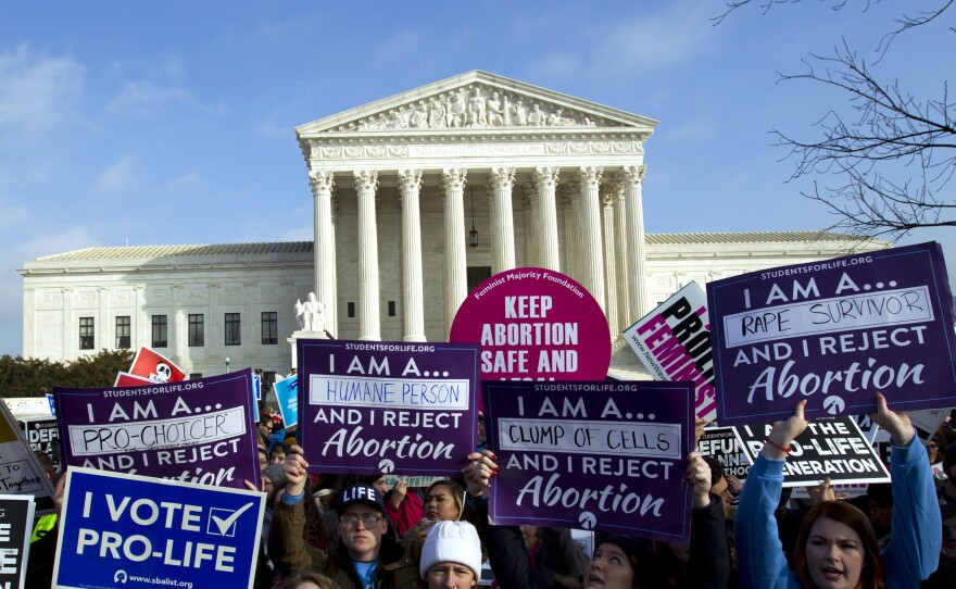 Anti-abortion activists protest outside of the U.S. Supreme Court. The Supreme Court has rejected laws that tie abortion rights to a specific week in a woman's pregnancy, but this is the first time a judge has struck down the 1973 law.