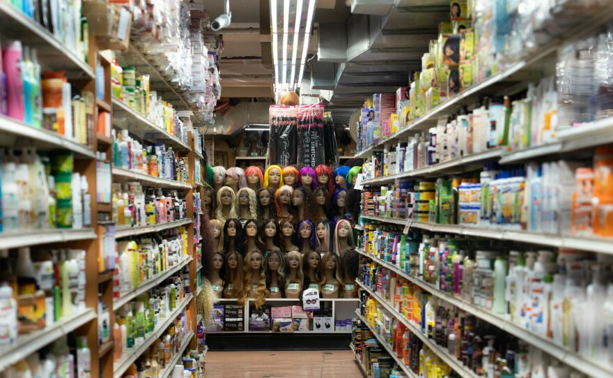Bob gets his wigs from local beauty supply stores like Manhattan Beauty. A full display of wigs is seen from the aisles in the back of the store.