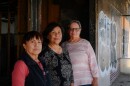 From left, longtime Niland residents Anna Garcia, Nellie Perez and Diana Juarez stand for a portrait in front of the old post office building in Niland in Imperial County on March 19, 2024. They lead the community advocacy group NorthEnd Alliance 111, which is fighting to bring the Niland Post Office back to the town.
