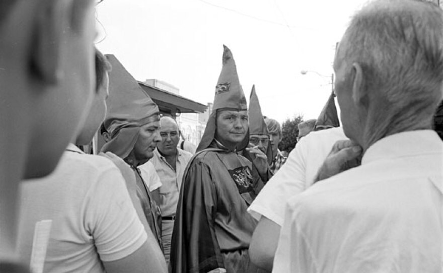 Bob Jones stands among Klan members at a Ku Klux Klan rally, August 1964.