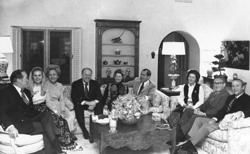 Gathered in the living room of the president's home at the Western White House in San Clemente on Jan. 6, 1971 are Richard Nixon and guests. From left to right are Bob Hope; Tricia Nixon; Pat Nixon; Gerald Ford, then minority leader of the House; Dolores Hope, Nixon; Betty Ford; Henry Kissinger; and Arnold Palmer.