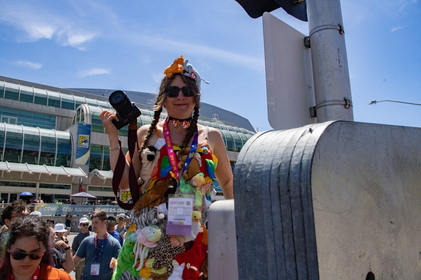 A cosplayer stands on a planted to get a better image in front of Comic-Con, April 23, 2026.
