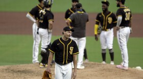 San Diego Padres starting pitcher Garrett Richards, center, reacts as he leaves the field during the fifth inning of an exhibition baseball game against the San Diego Padres at Petco Park Monday, July 20, 2020, in San Diego. 
