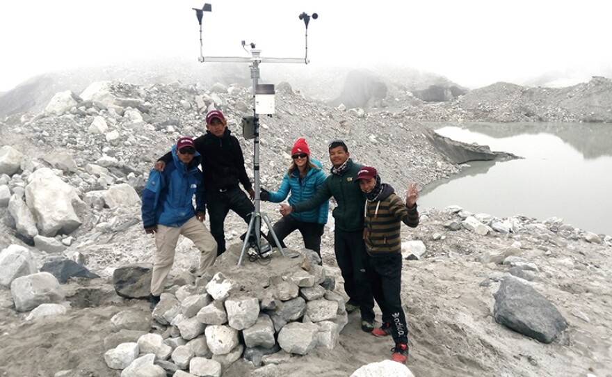 Glaciologist Ulyana Horodyskyj stands with members of the Sherpa Science Initiative (SSI) after rebuilding a weather station in the foothills of the Himalayas, Nepal, damaged during the 2015 earthquake. SSI trains the Sherpa to monitor the instruments year-round, contributing to science and also to understanding possible floods in their local environment.