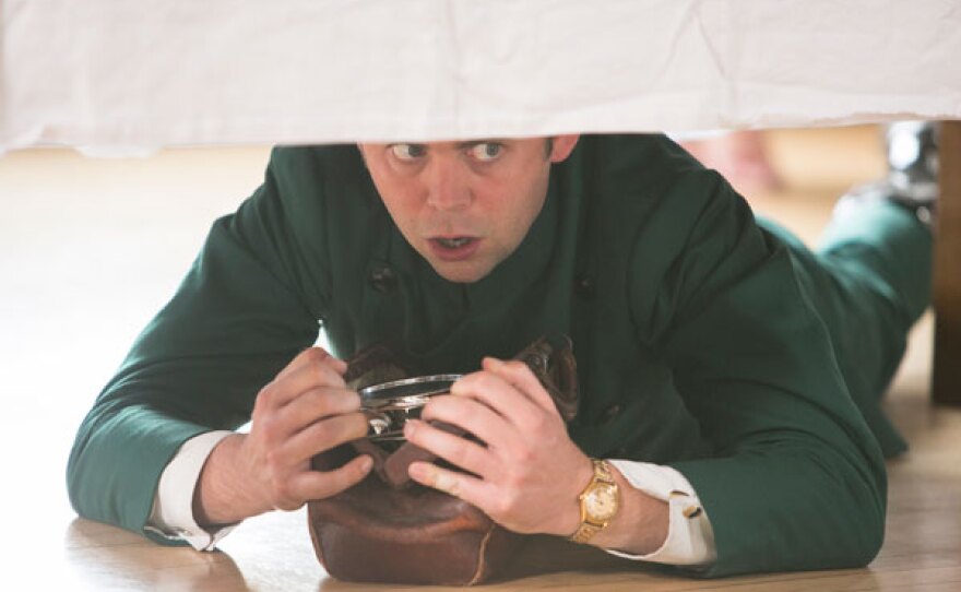 Sid (Alex Price) peers under the table. He finds the bomb.