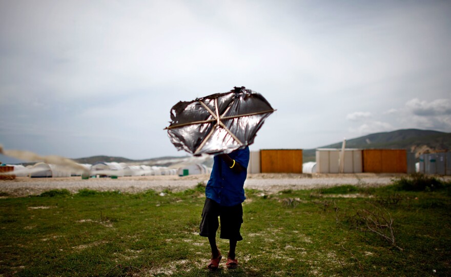 A little boy tries to get his kite in to the air at Camp Corail in Croiz de Bouquets outside of Port-au-Prince Haiti on May 4, 2010. Internally displaced people living in makeshift camps in the city were moved to the Corail camp in an attempt to give the people a safer and more permanent living situation.